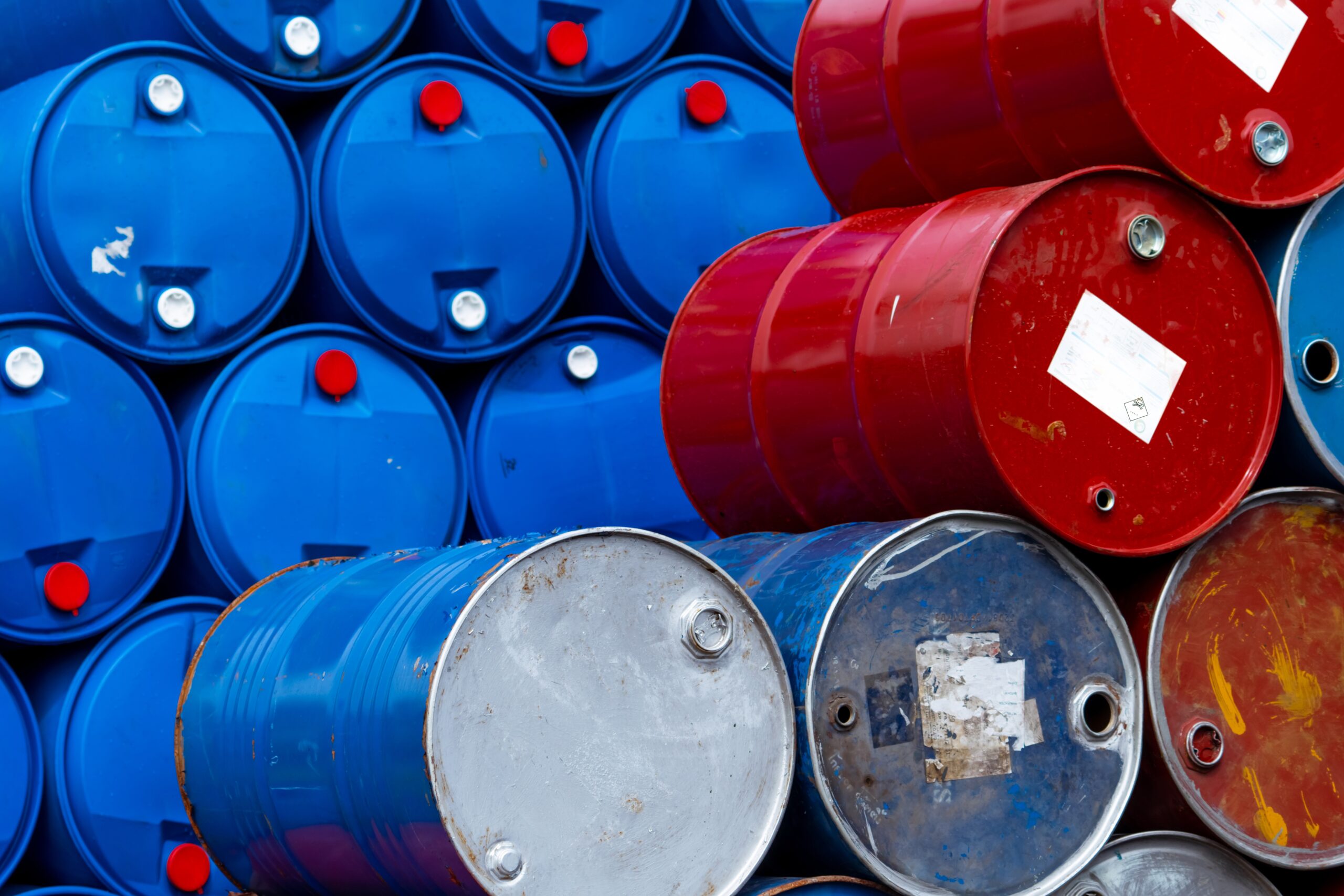 Old chemical barrels. Blue and red oil drum.